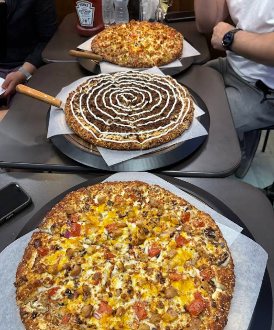Three freshly prepared pizzas at Royal Crown Pizza in New Westminster